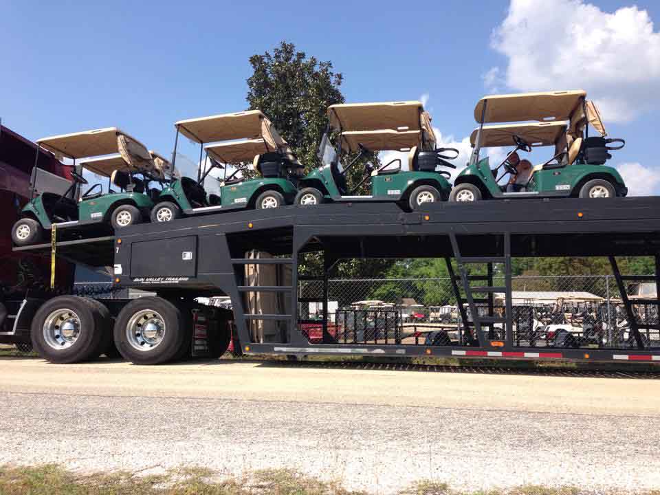 Truck full of green Golf Carts